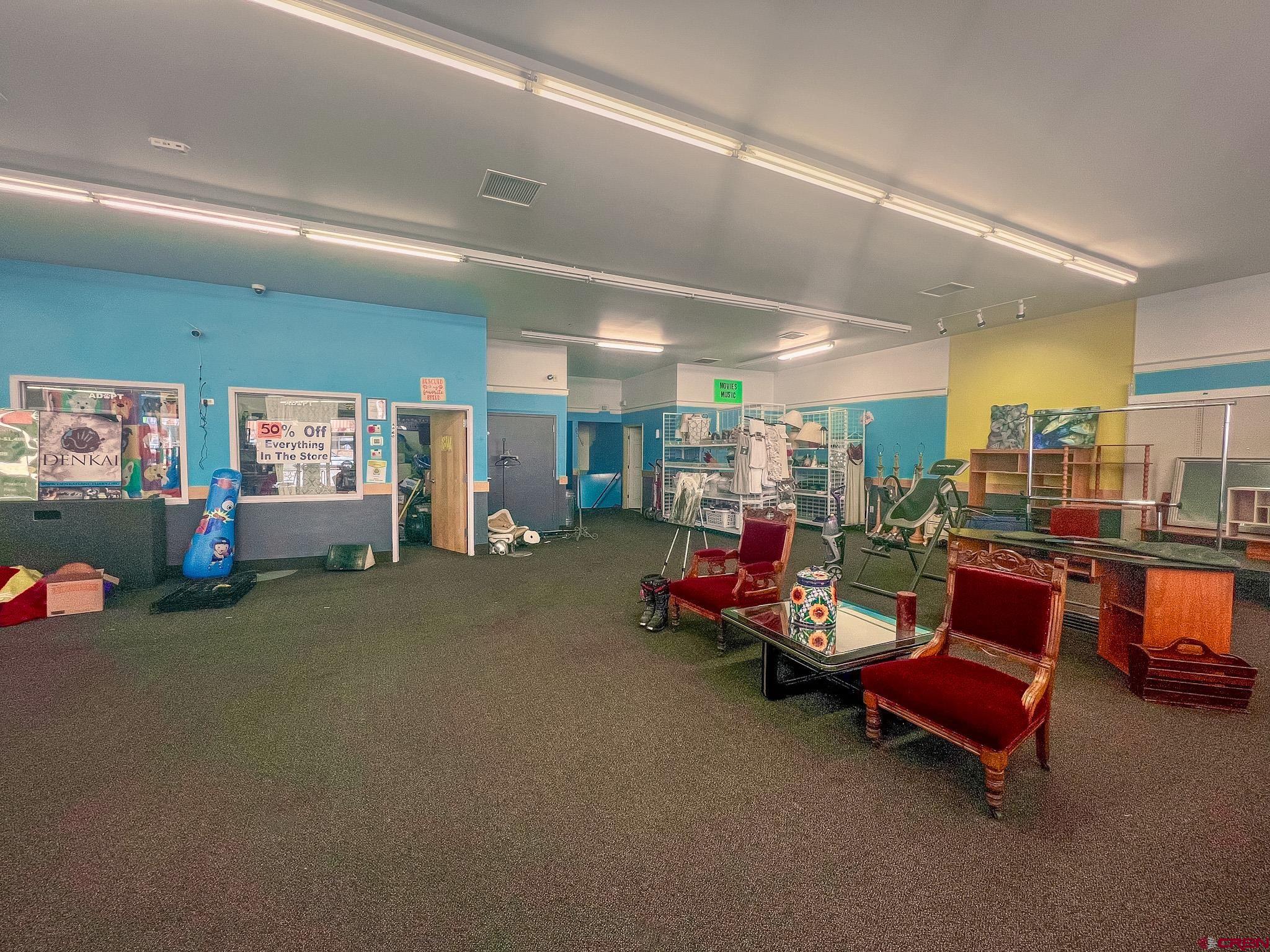 209 West Main Street Cortez, CO 81321 - Photo 11 of 18 a living room with lots of furniture and gym equipment