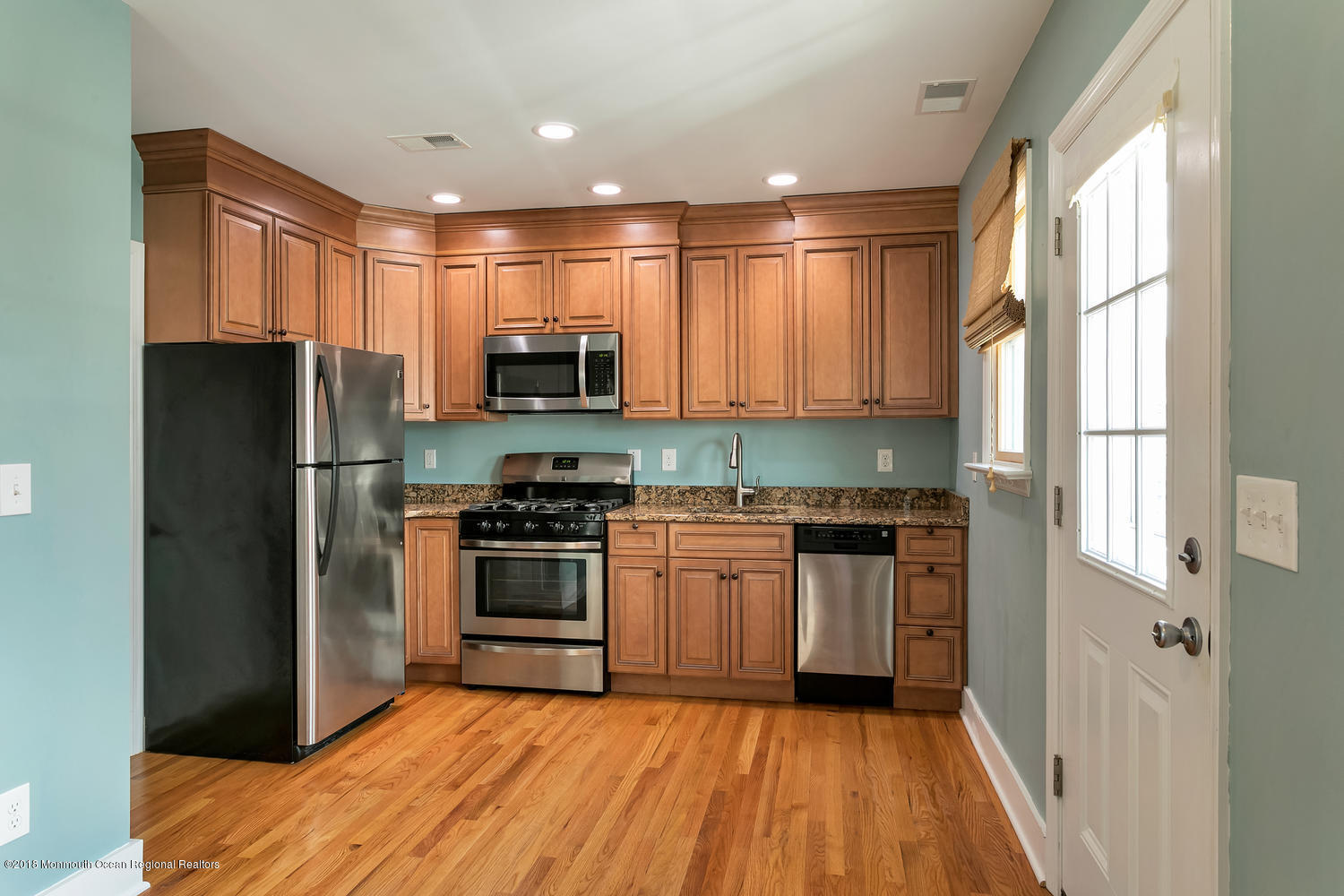 1 Beach Way, Unit A Sea Bright, NJ 07760 - Photo 5 of 15 a kitchen with a refrigerator a stove top oven a sink and a window