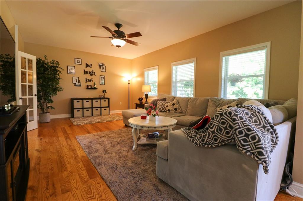 342 Weber Road Sewickley, PA 15143 - Photo 5 of 25 Hardwood Floors, Window Blinds, and Overhead Lighted Ceiling Fan Add Cozy and Comfort to the Living Room.
