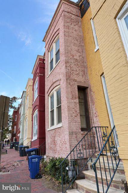 a view of a brick house with many windows