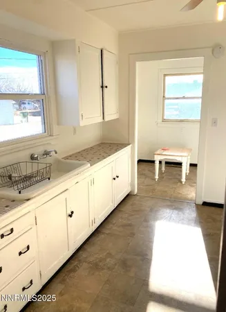 a bathroom with a sink a toilet and a window