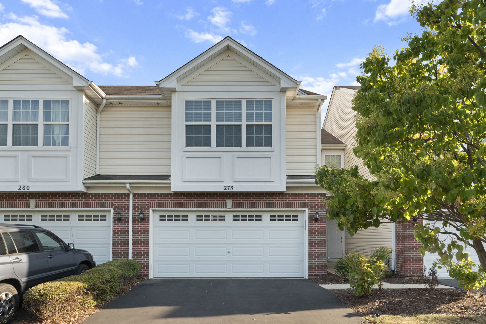 278 South Oak Creek Lane Romeoville, IL 60446 - Photo 1 of 16 a front view of a house with a yard and garage