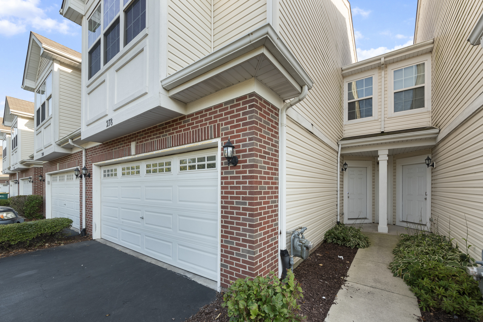 278 South Oak Creek Lane Romeoville, IL 60446 - Photo 2 of 16 a front view of a house with a garage