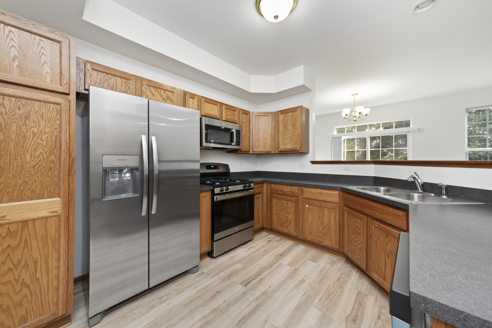 278 South Oak Creek Lane Romeoville, IL 60446 - Photo 3 of 16 a kitchen with stainless steel appliances granite countertop a refrigerator a sink dishwasher a stove and a refrigerator