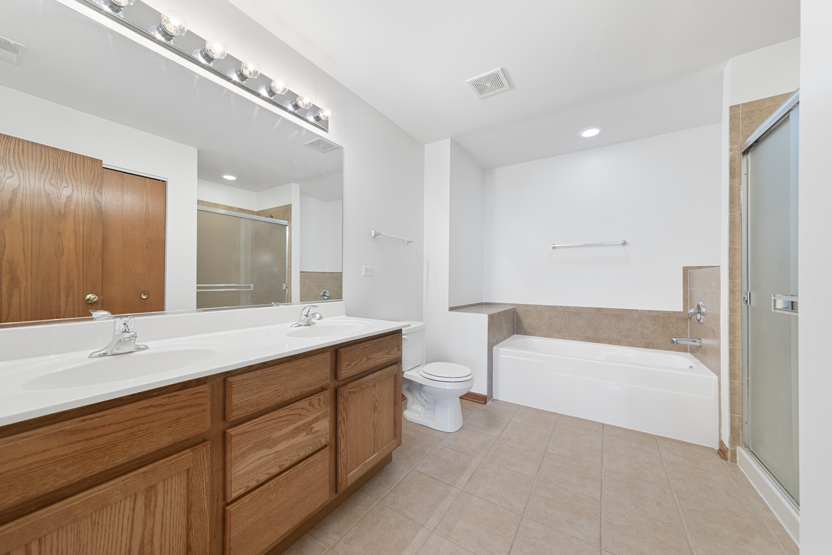278 South Oak Creek Lane Romeoville, IL 60446 - Photo 10 of 16 a bathroom with a sink double vanity granite tub and a mirror