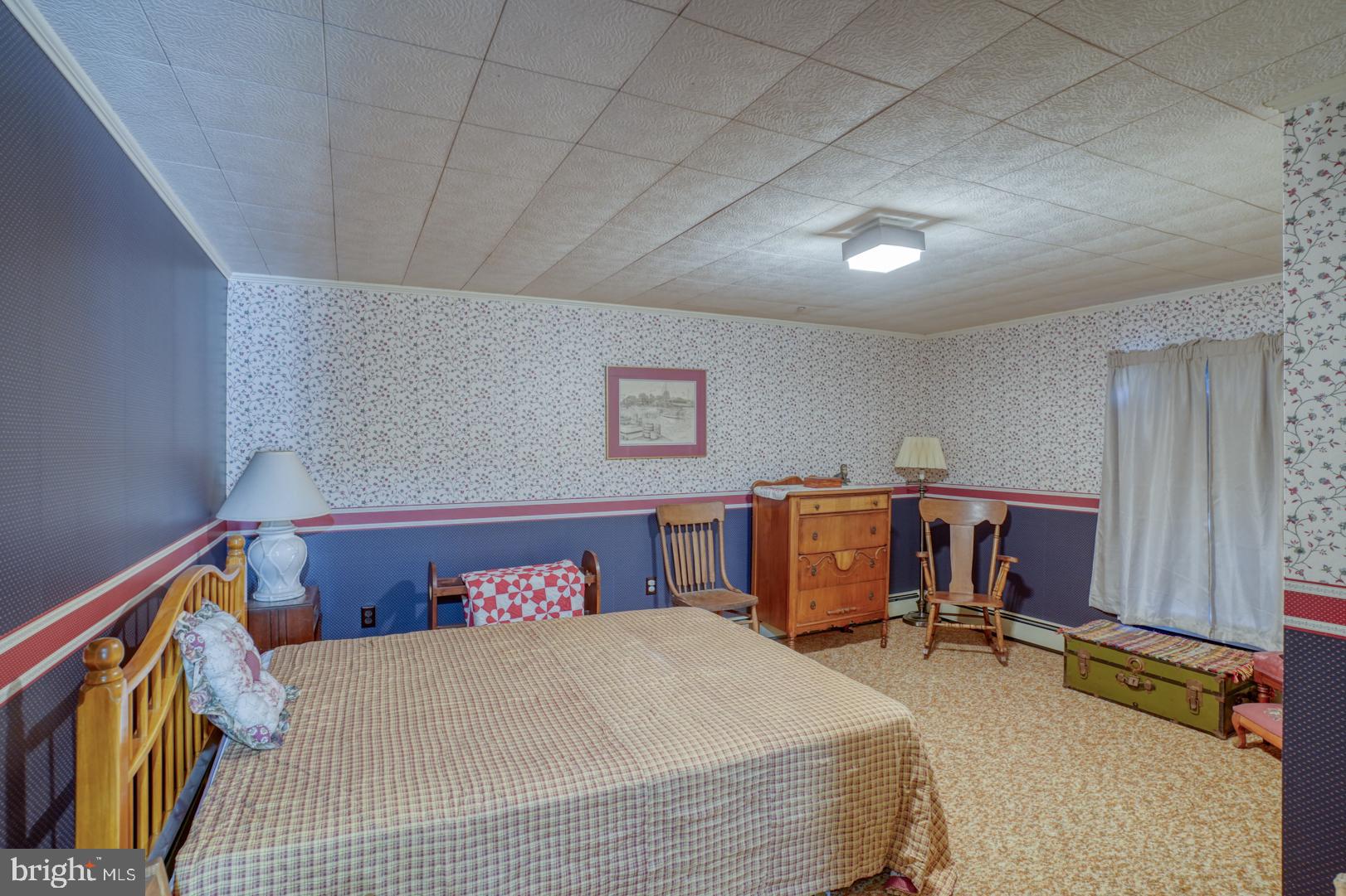 20730 Bucks Branch Road Seaford, DE 19973 - Photo 54 of 64 a bedroom with a large bed and a desk