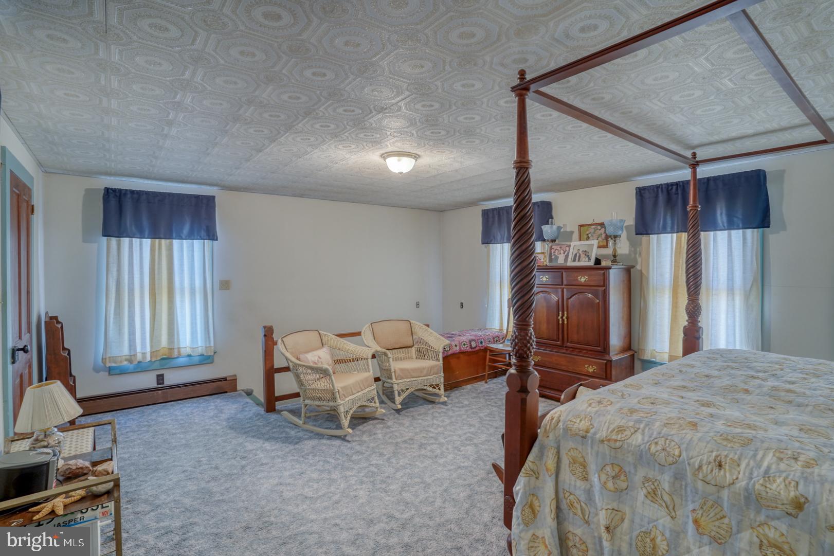 20730 Bucks Branch Road Seaford, DE 19973 - Photo 61 of 64 a spacious bedroom with a bed and a chandelier