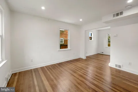 a view of an empty room and wooden floor