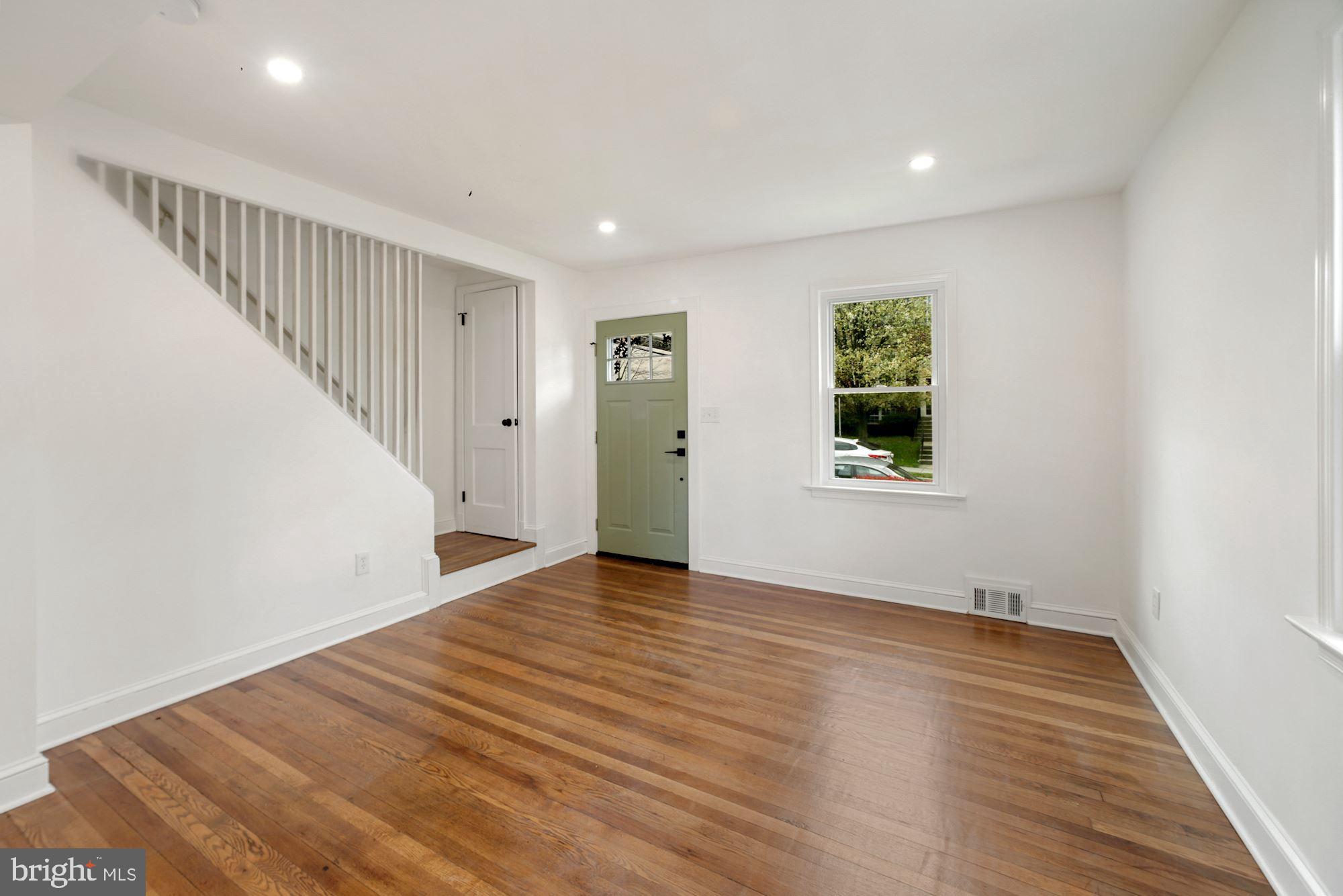 1530 Howard Road Southeast Washington, DC 20020 - Photo 4 of 32 wooden floor in an empty room with a window