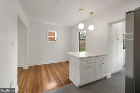 a view of a room with cabinets and wooden floor