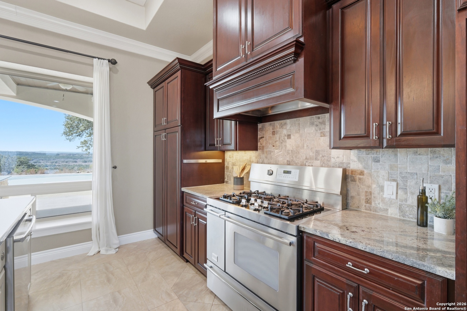 1030 Mystic Parkway Spring Branch, TX 78070 - Photo 13 of 63 a kitchen with stainless steel appliances granite countertop a stove and a refrigerator