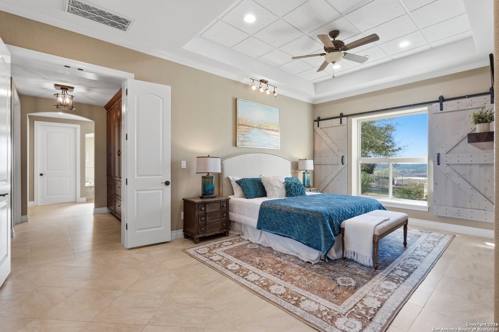 1030 Mystic Parkway Spring Branch, TX 78070 - Photo 21 of 63 a spacious bedroom with a large bed and a chandelier