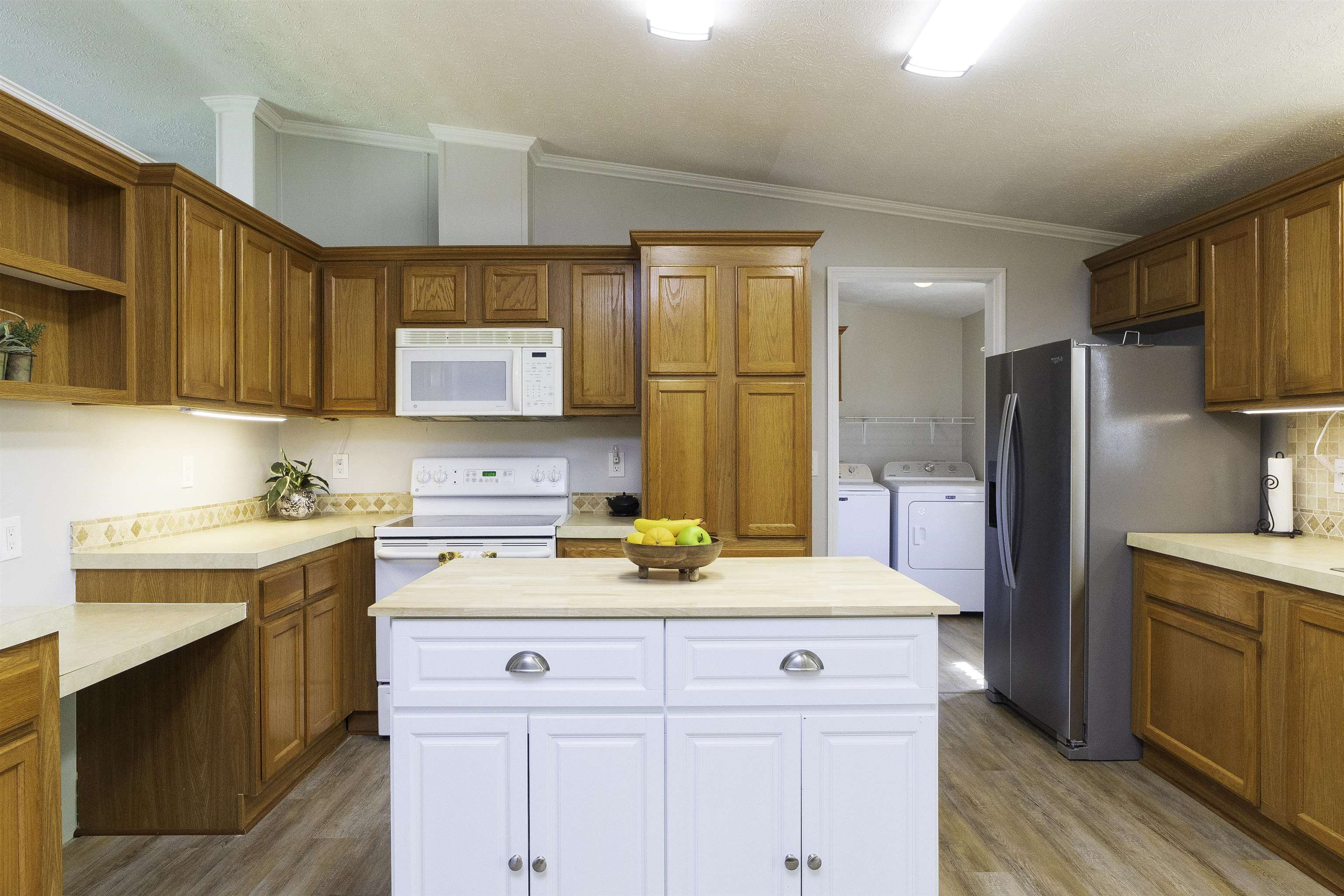2232 Whippoorwill Drive St. Augustine, FL 32084 - Photo 11 of 51 a kitchen with a sink a stove a refrigerator and cabinets