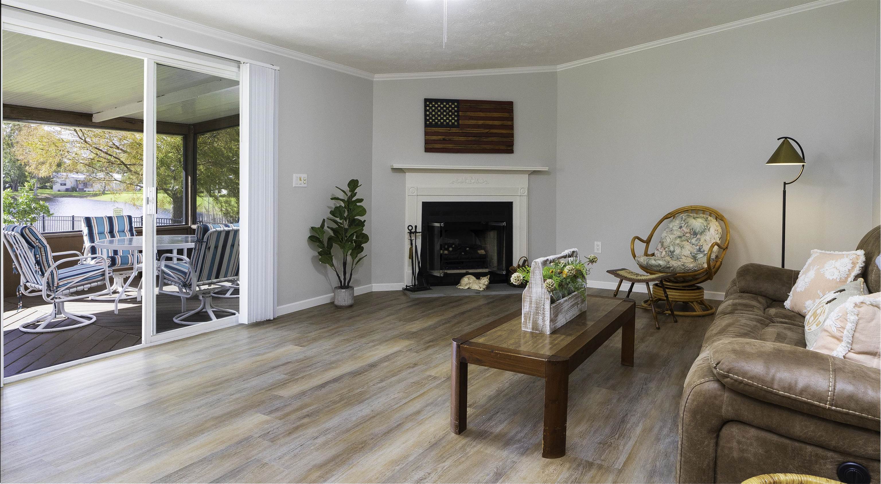 2232 Whippoorwill Drive St. Augustine, FL 32084 - Photo 18 of 51 a living room with furniture a fireplace and a floor to ceiling window
