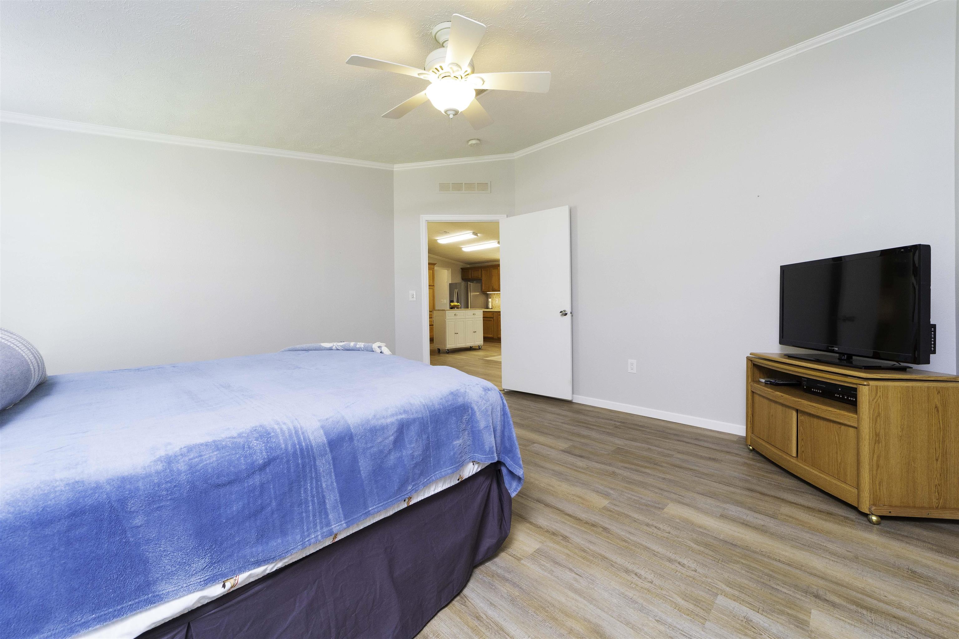 2232 Whippoorwill Drive St. Augustine, FL 32084 - Photo 20 of 51 a bedroom with a bed and a flat screen tv