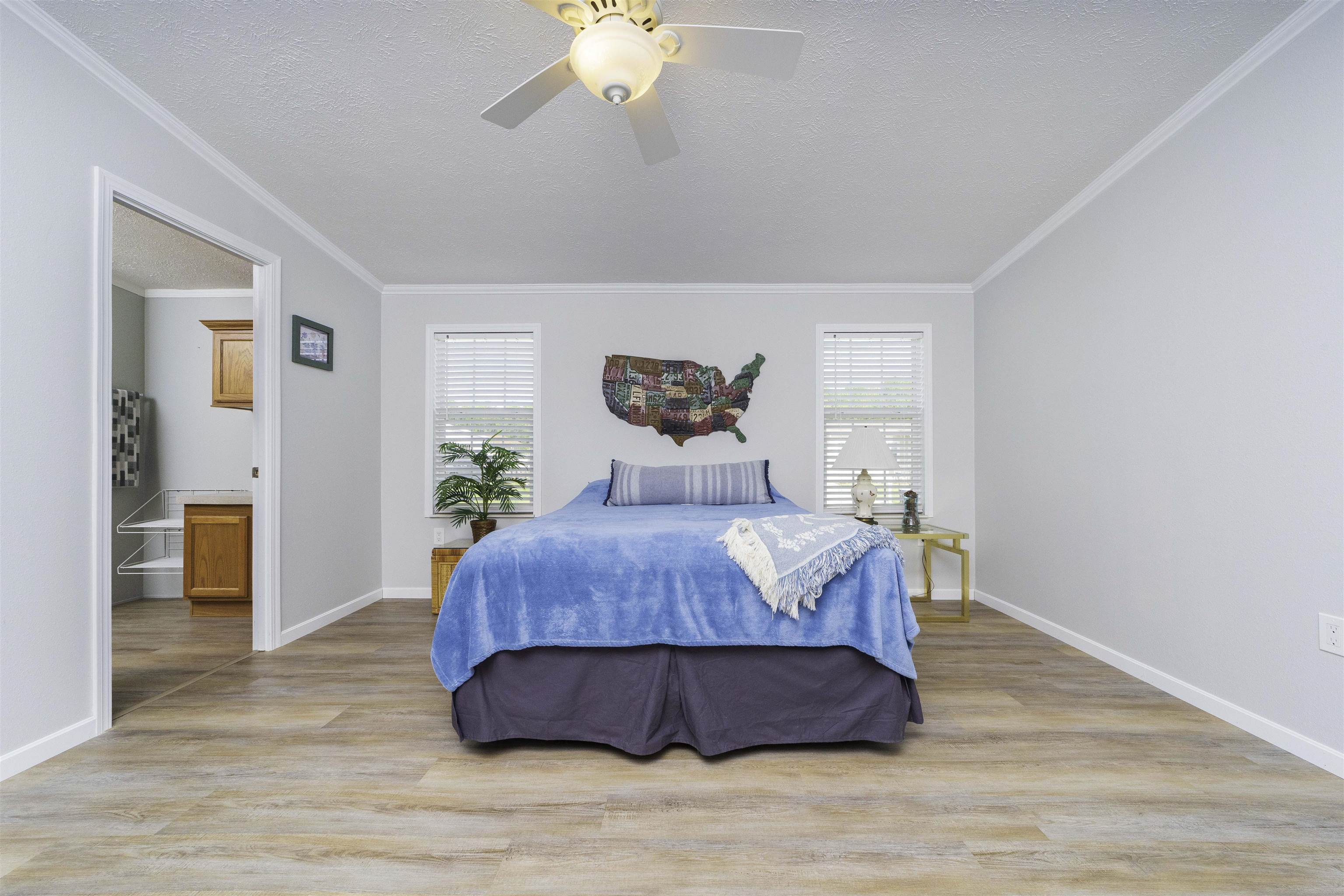 2232 Whippoorwill Drive St. Augustine, FL 32084 - Photo 21 of 51 a bedroom with a bed and a chandelier
