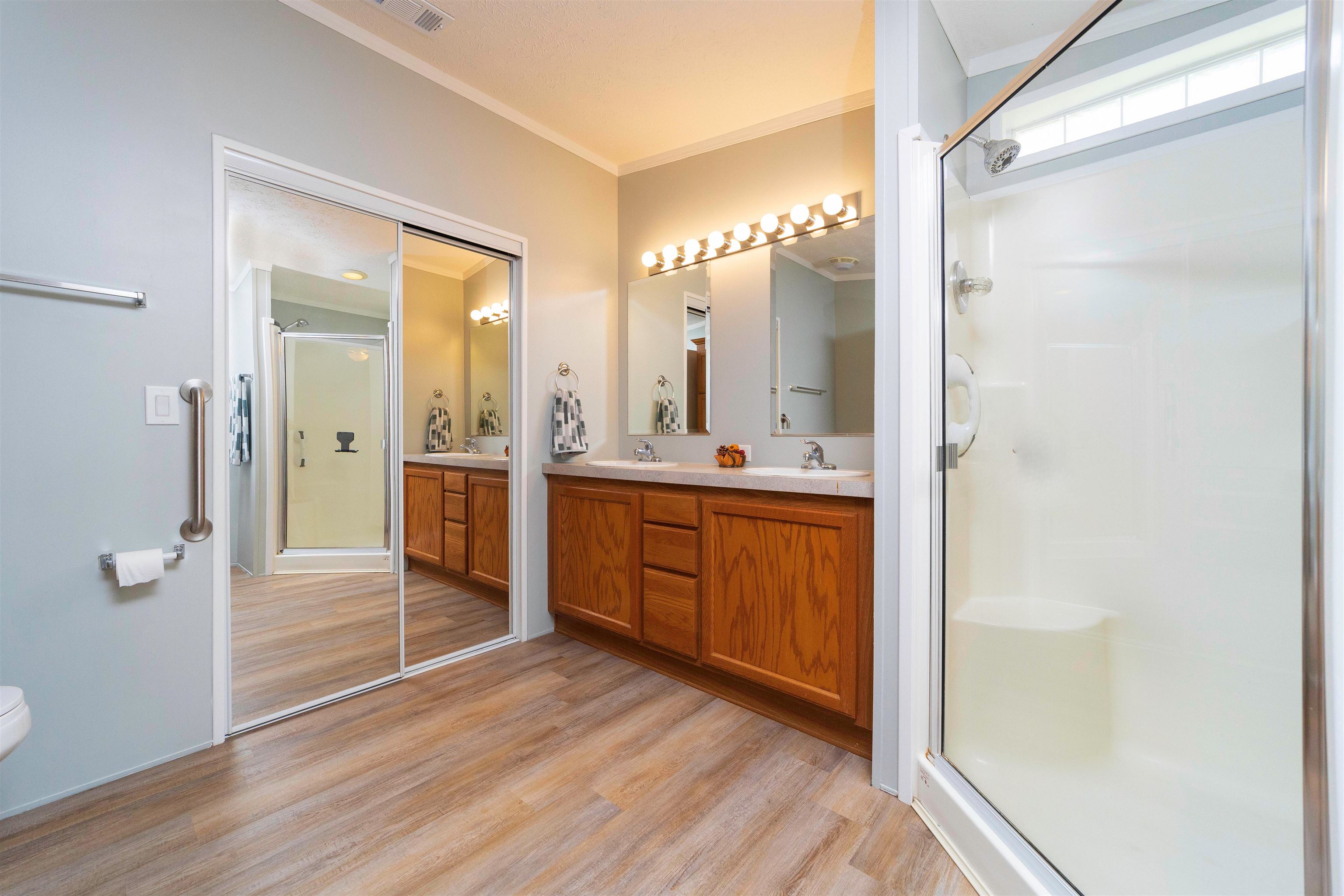 2232 Whippoorwill Drive St. Augustine, FL 32084 - Photo 24 of 51 a bathroom with a double vanity sink a mirror and a shower