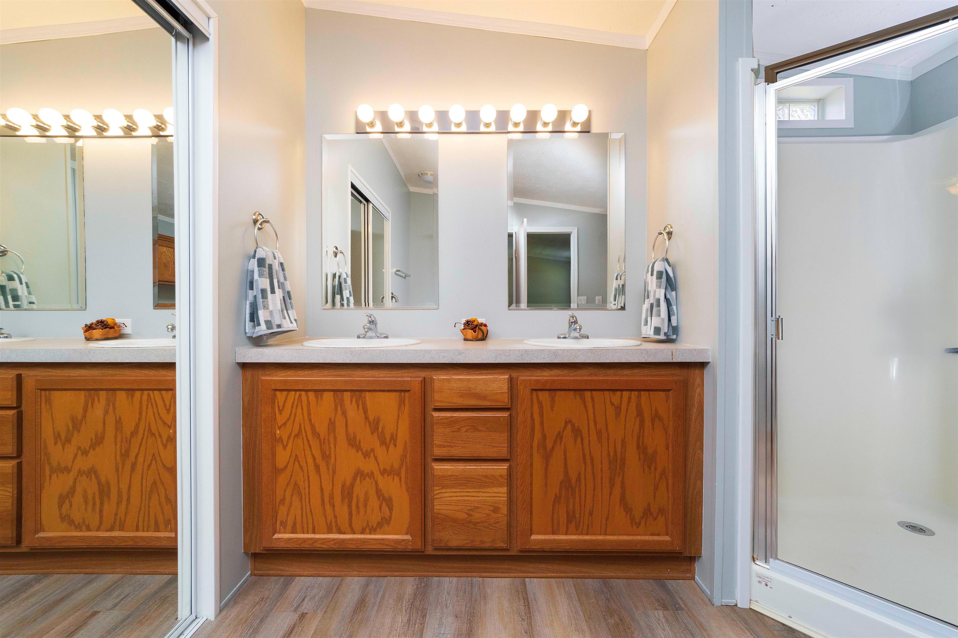 2232 Whippoorwill Drive St. Augustine, FL 32084 - Photo 25 of 51 a bathroom with a double vanity sink and a mirror