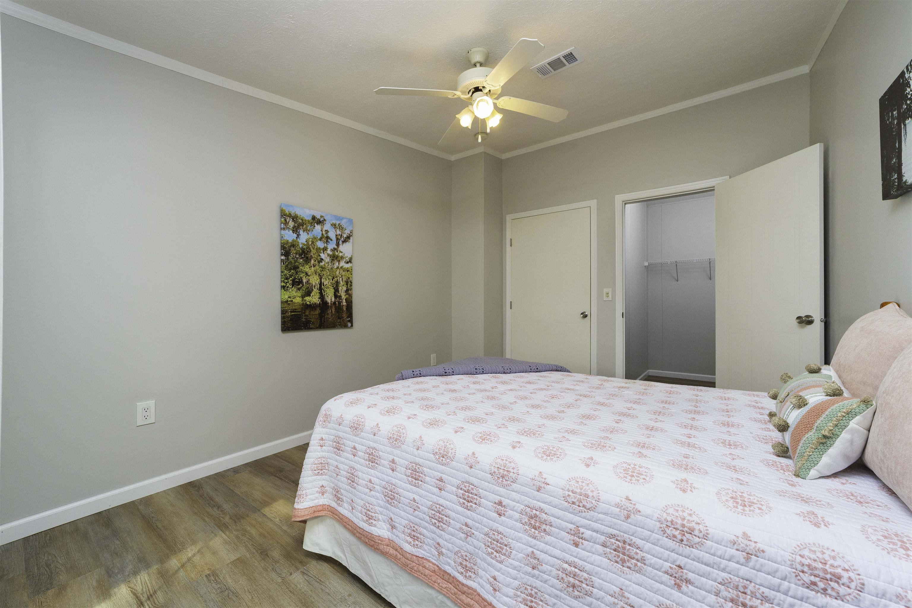2232 Whippoorwill Drive St. Augustine, FL 32084 - Photo 30 of 51 a bedroom with a bed and a chandelier