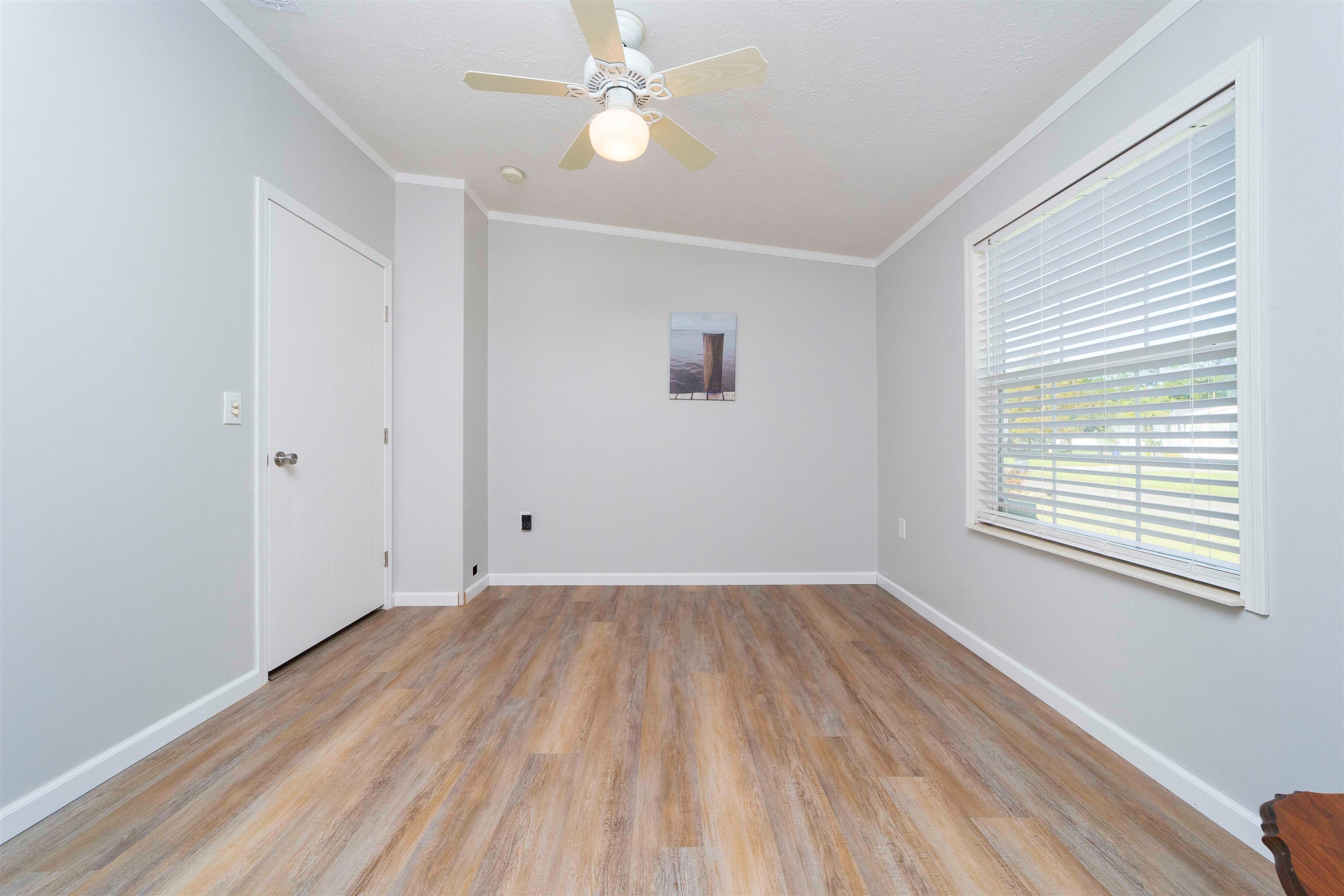 2232 Whippoorwill Drive St. Augustine, FL 32084 - Photo 34 of 51 wooden floor in an empty room with a window