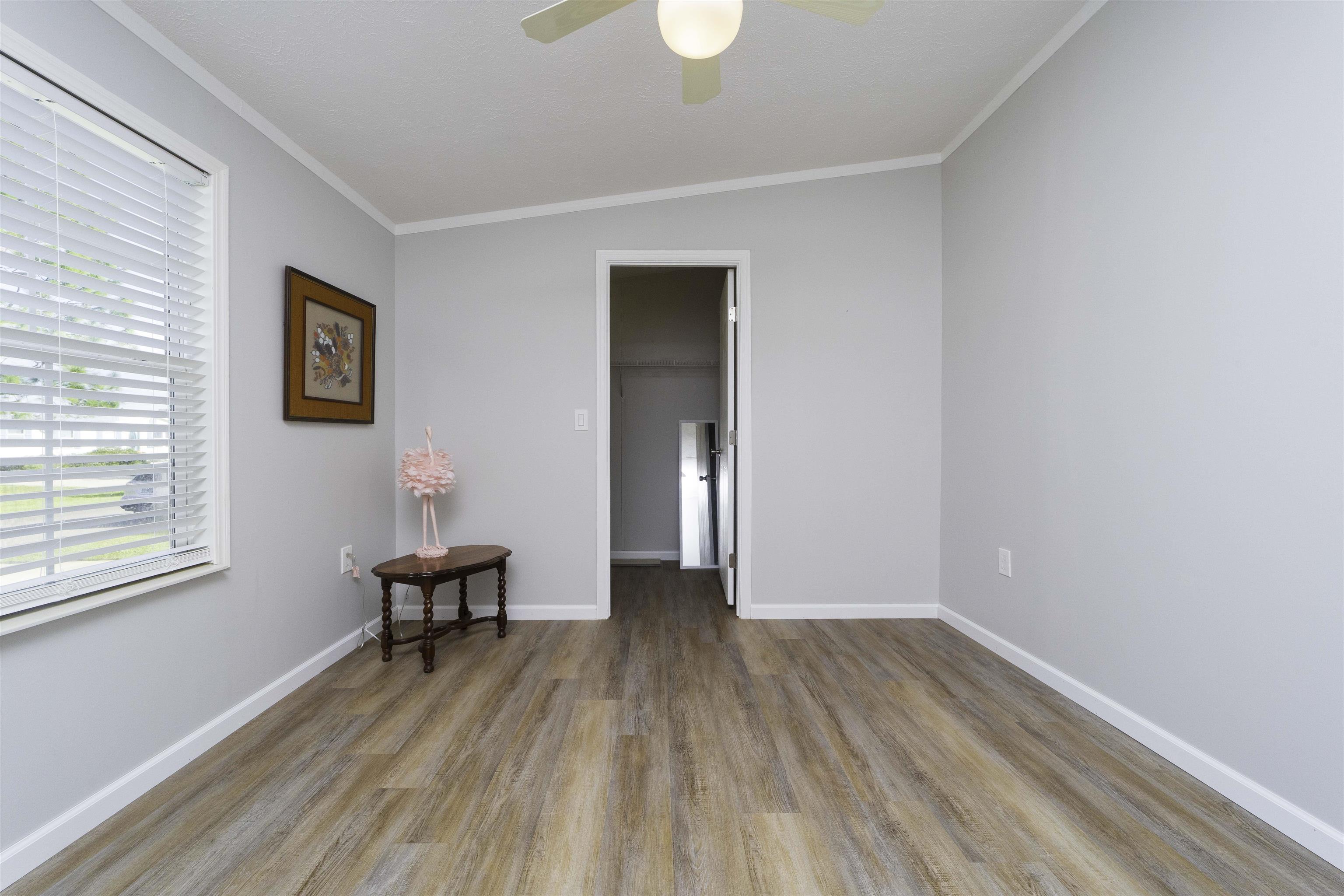 2232 Whippoorwill Drive St. Augustine, FL 32084 - Photo 36 of 51 a view of empty room with wooden floor and fan