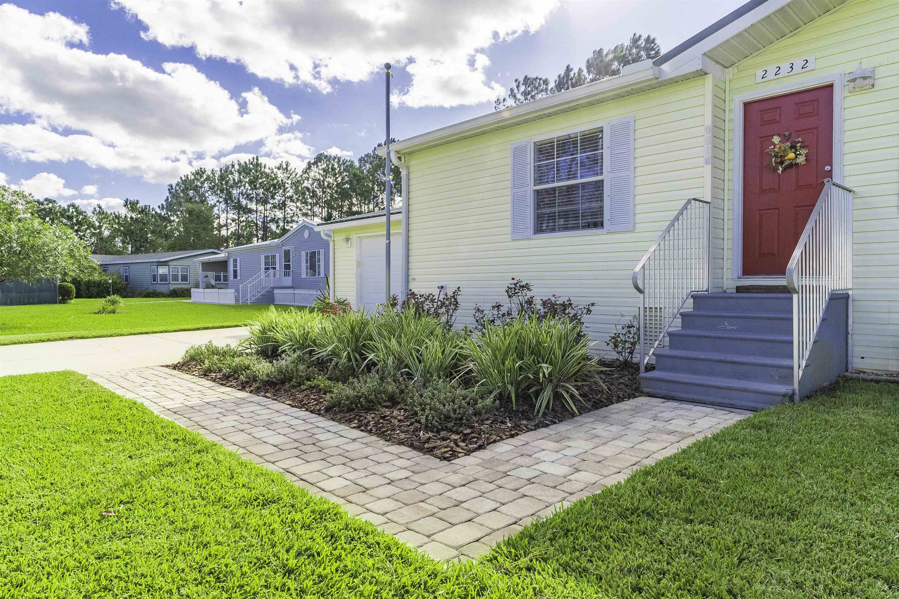 2232 Whippoorwill Drive St. Augustine, FL 32084 - Photo 4 of 51 a view of a house with backyard and garden