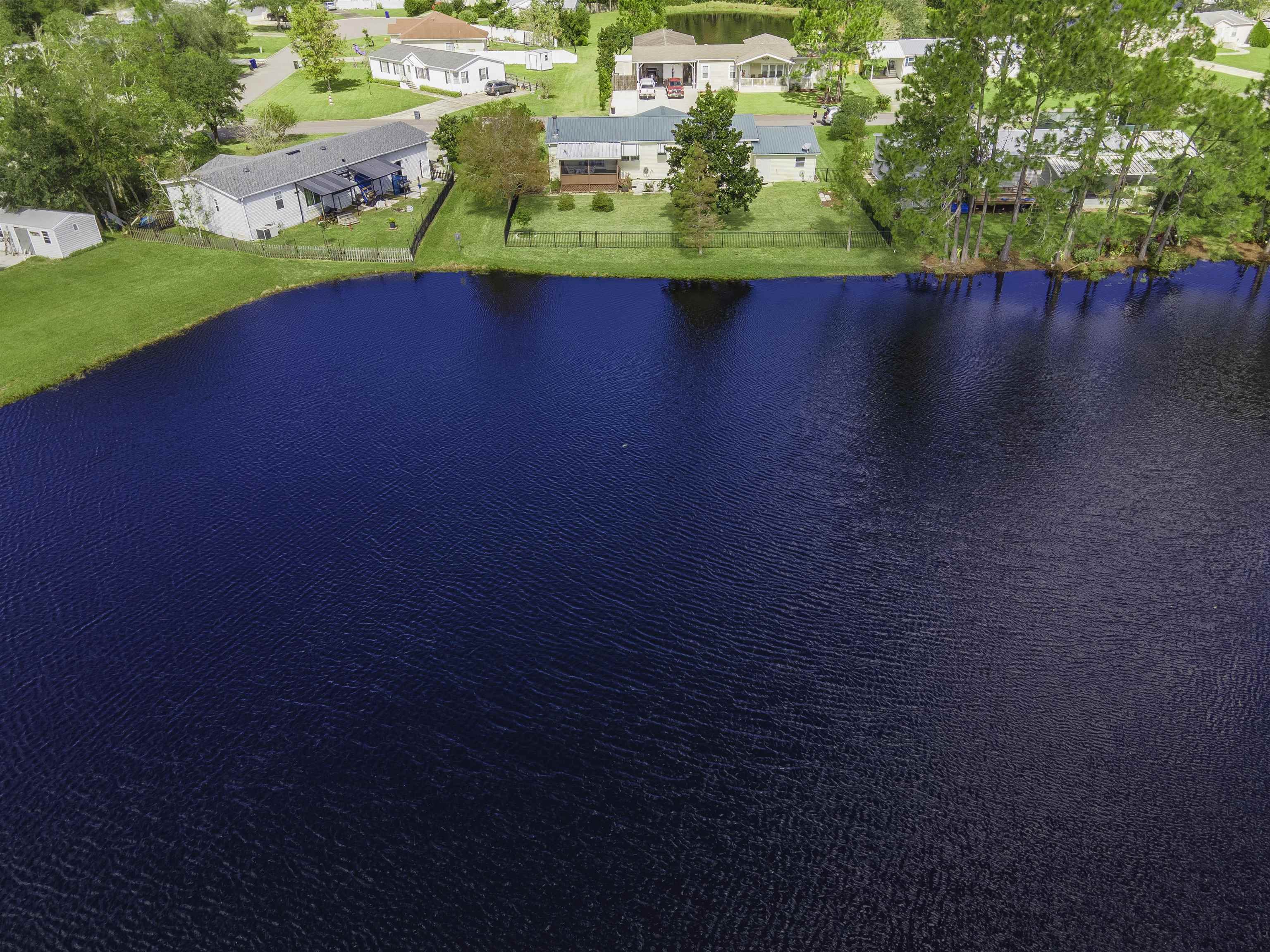 2232 Whippoorwill Drive St. Augustine, FL 32084 - Photo 46 of 51 a view of a lake with a big yard