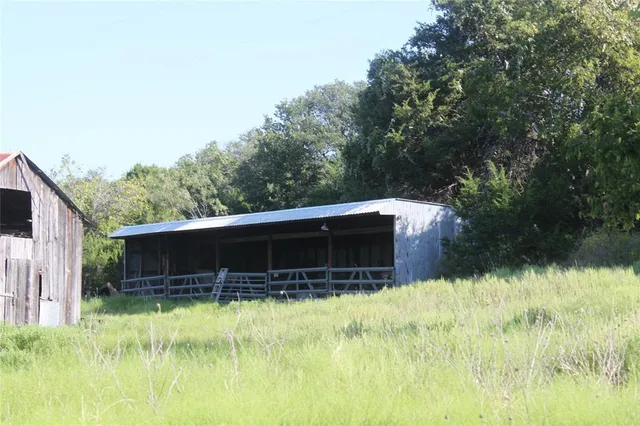 a view of house with backyard and garden