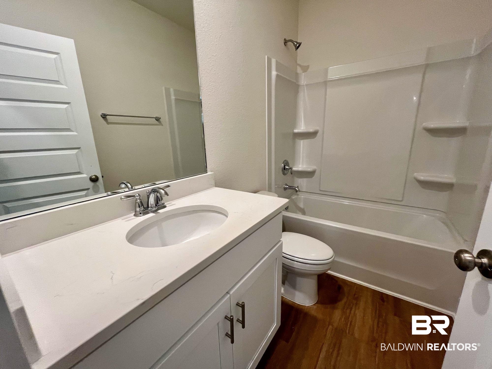 337 Barndling Street Fairhope, AL 36532 - Photo 20 of 34 Full bathroom featuring wood-type flooring, vanity, toilet, and shower / bathing tub combination