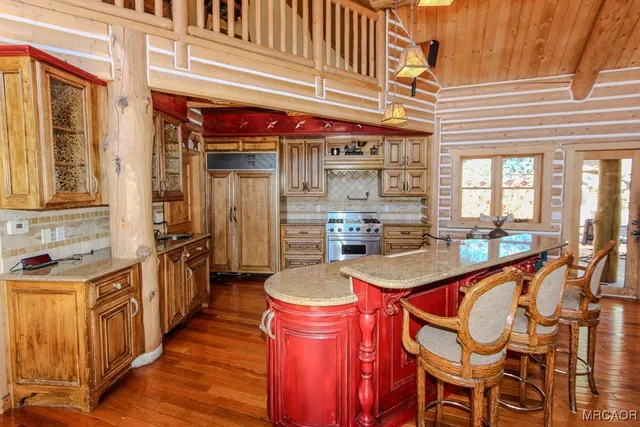 a kitchen with stainless steel appliances granite countertop a sink and cabinets