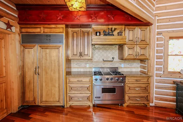 a kitchen with stainless steel appliances granite countertop a stove and a refrigerator