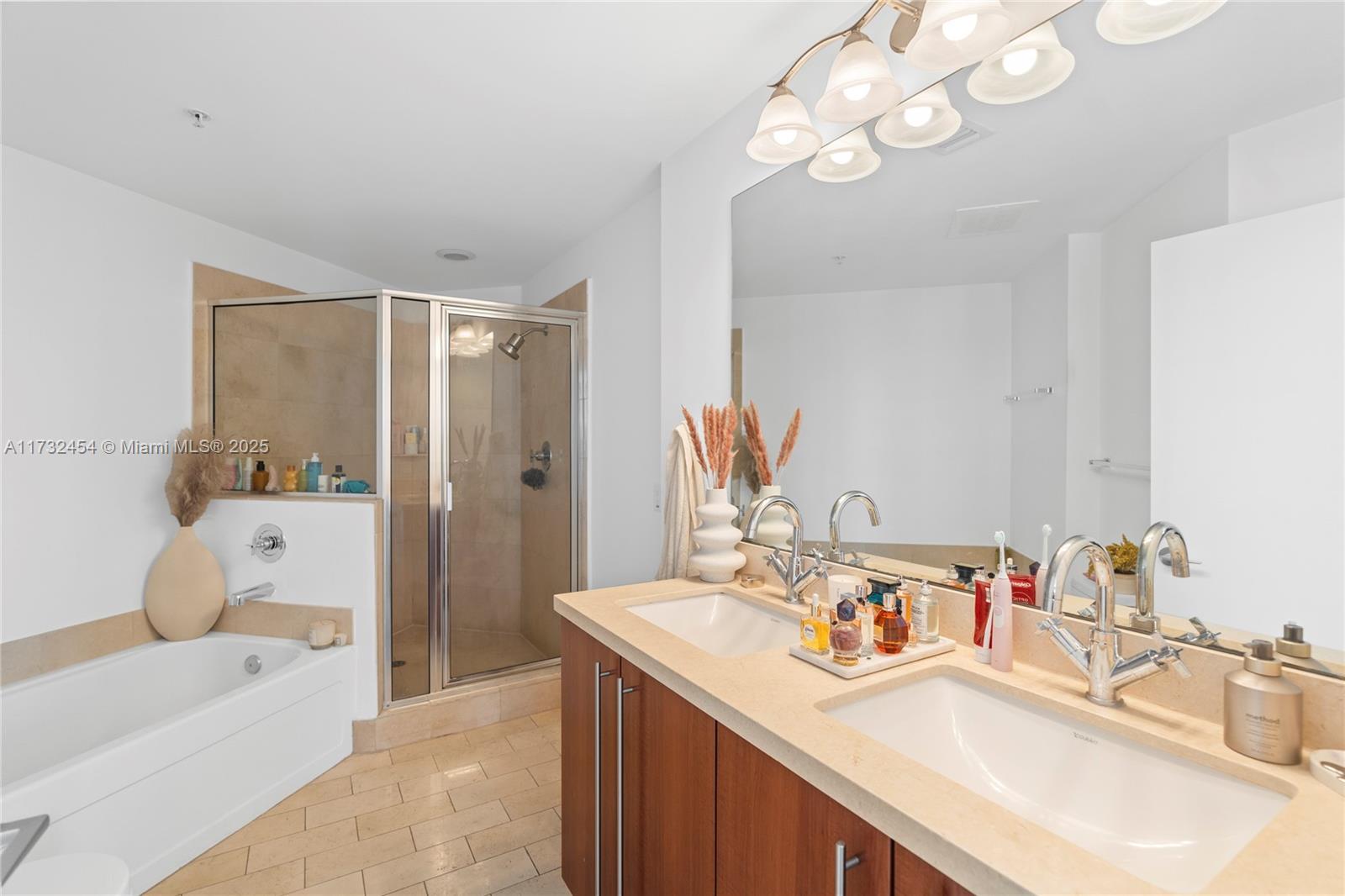 79 Southwest 12th Street, Unit 2001S Miami, FL 33130 - Photo 11 of 29 a bathroom with a sink double vanity granite tub shower and a mirror