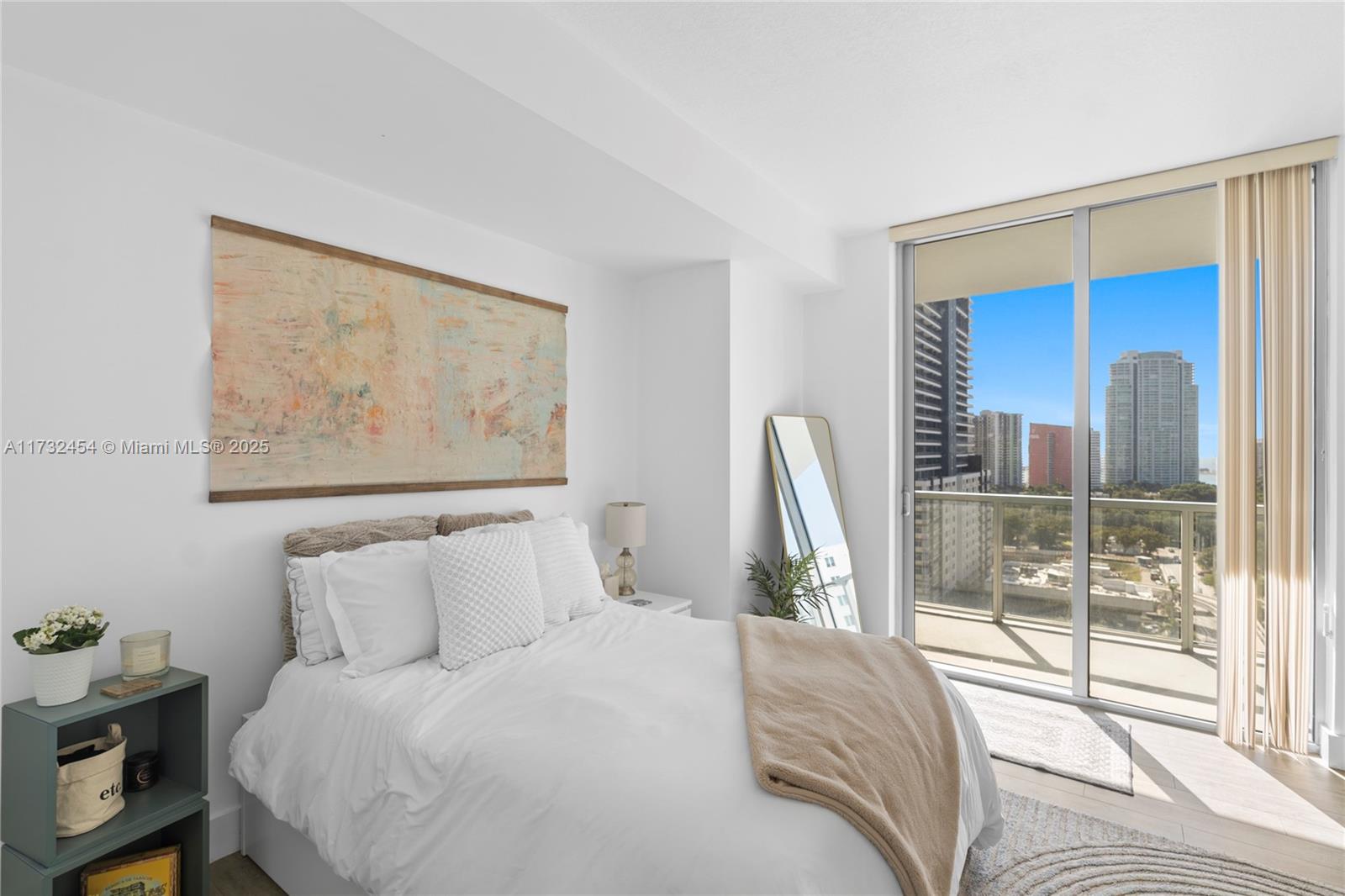 79 Southwest 12th Street, Unit 2001S Miami, FL 33130 - Photo 13 of 29 a bedroom with a bed and a painting on the wall