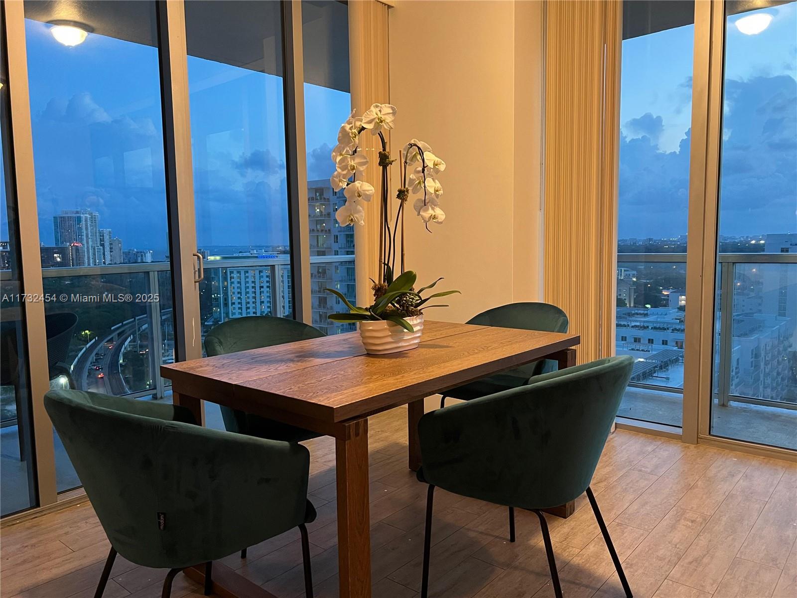 79 Southwest 12th Street, Unit 2001S Miami, FL 33130 - Photo 4 of 29 a view of a dining room with furniture and wooden floor