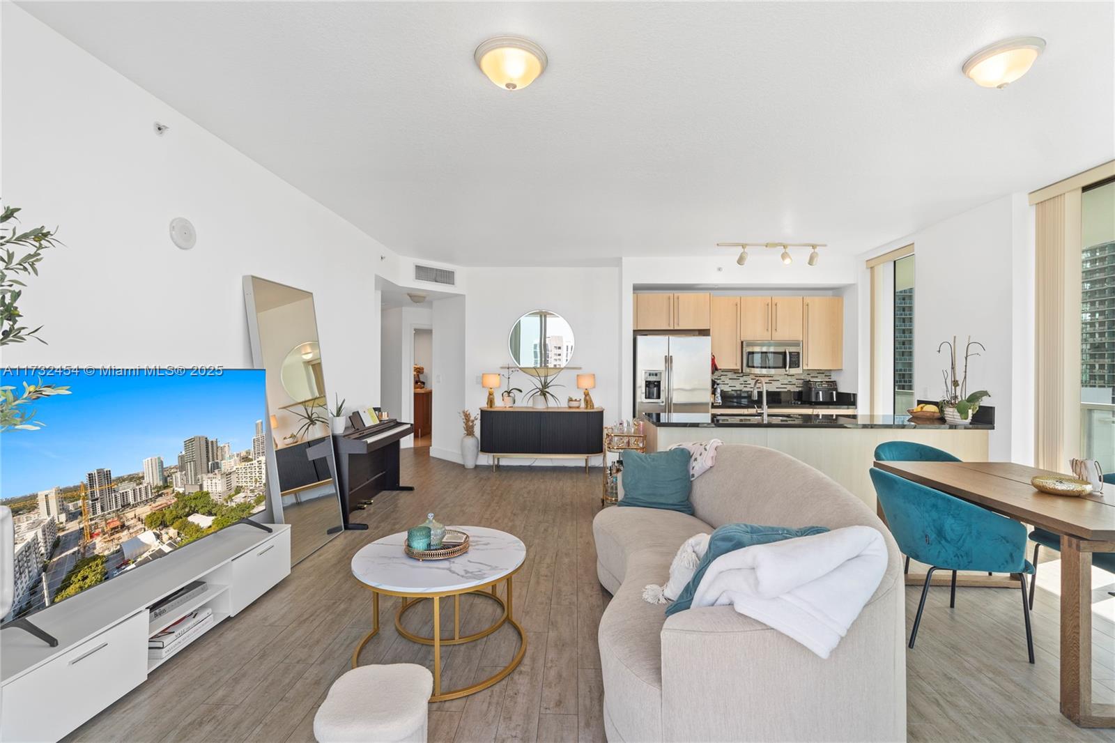 79 Southwest 12th Street, Unit 2001S Miami, FL 33130 - Photo 7 of 29 a living room with furniture and a table