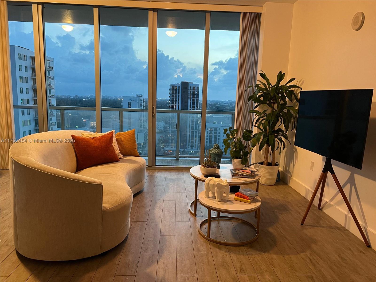 79 Southwest 12th Street, Unit 2001S Miami, FL 33130 - Photo 8 of 29 a living room with furniture and a floor to ceiling window