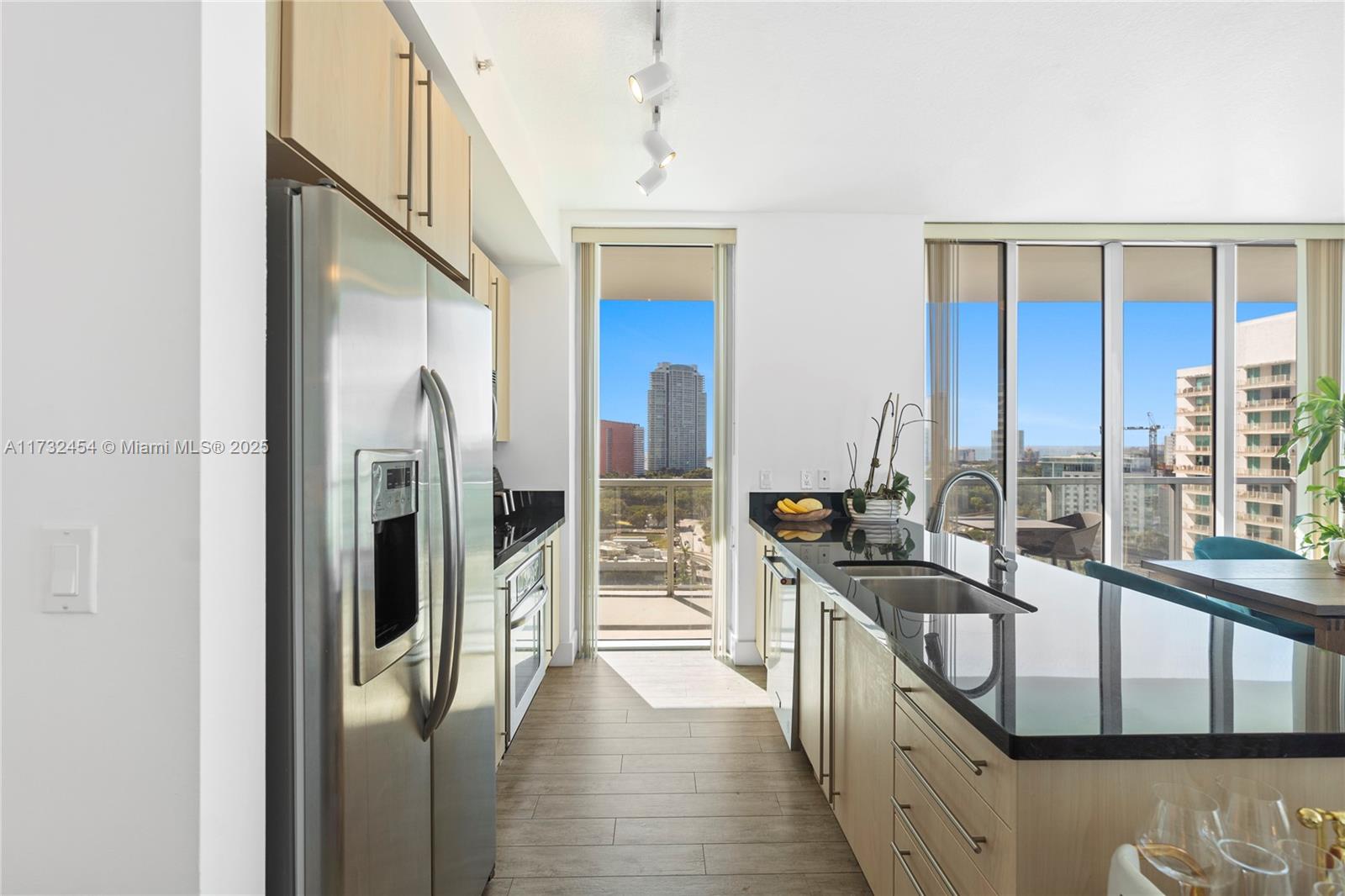 79 Southwest 12th Street, Unit 2001S Miami, FL 33130 - Photo 9 of 29 a view of a kitchen with a sink and refrigerator
