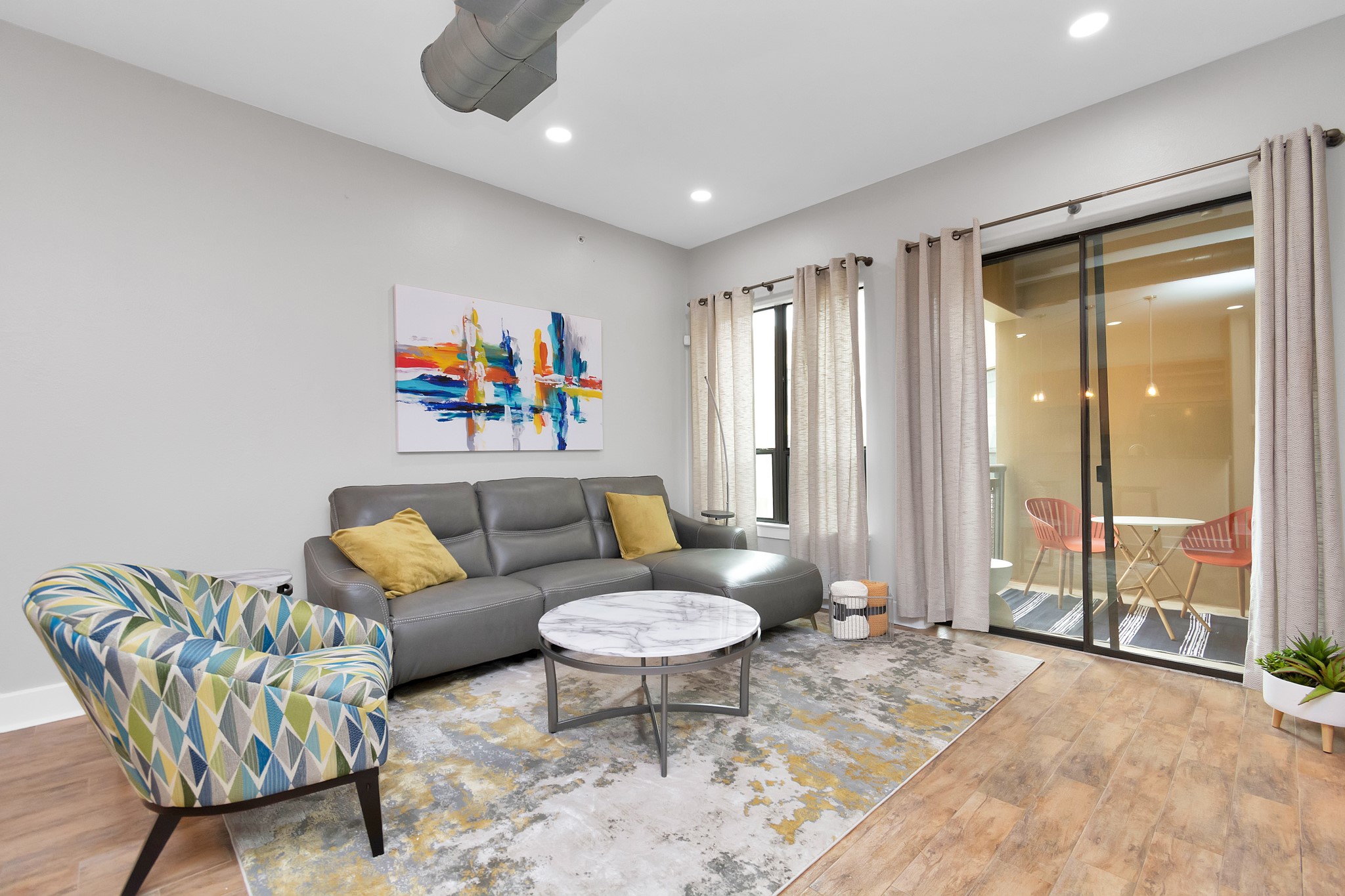 1901 Post Oak Boulevard, Unit 3113 Houston, TX 77056 - Photo 5 of 34 The living area shares an open space with the kitchen and dining area, pops of color and high ceilings bring an unified look to the space.