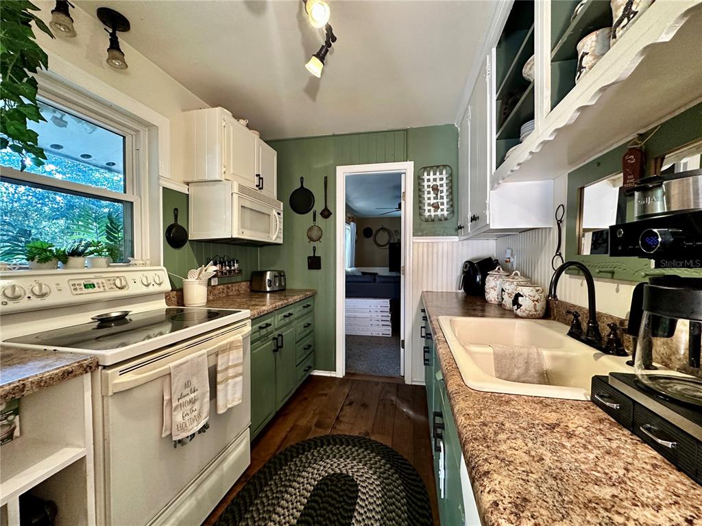 13565 Northeast 38th Avenue Anthony, FL 32617 - Photo 13 of 39 a kitchen with stainless steel appliances granite countertop a stove sink and cabinets