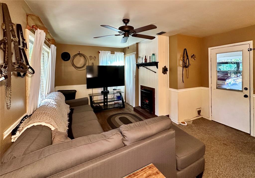13565 Northeast 38th Avenue Anthony, FL 32617 - Photo 14 of 39 a living room with furniture and a flat screen tv
