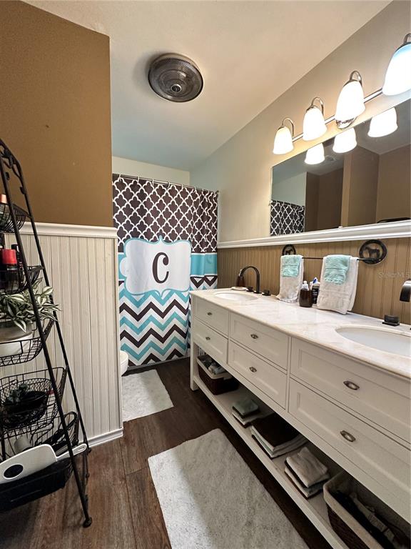 13565 Northeast 38th Avenue Anthony, FL 32617 - Photo 16 of 39 a bedroom with a bed and a chandelier