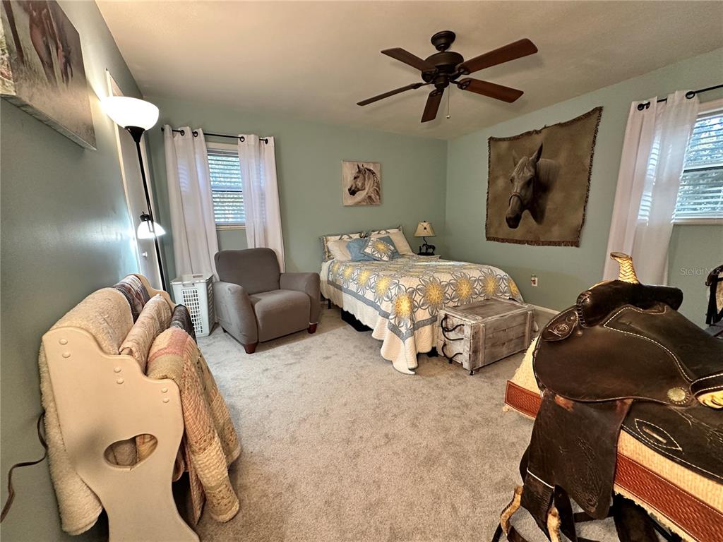 13565 Northeast 38th Avenue Anthony, FL 32617 - Photo 17 of 39 a bedroom with bed and a chandelier