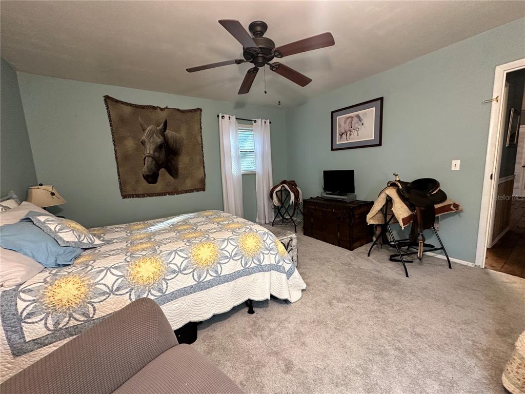 13565 Northeast 38th Avenue Anthony, FL 32617 - Photo 18 of 39 a bedroom with bed and a chandelier