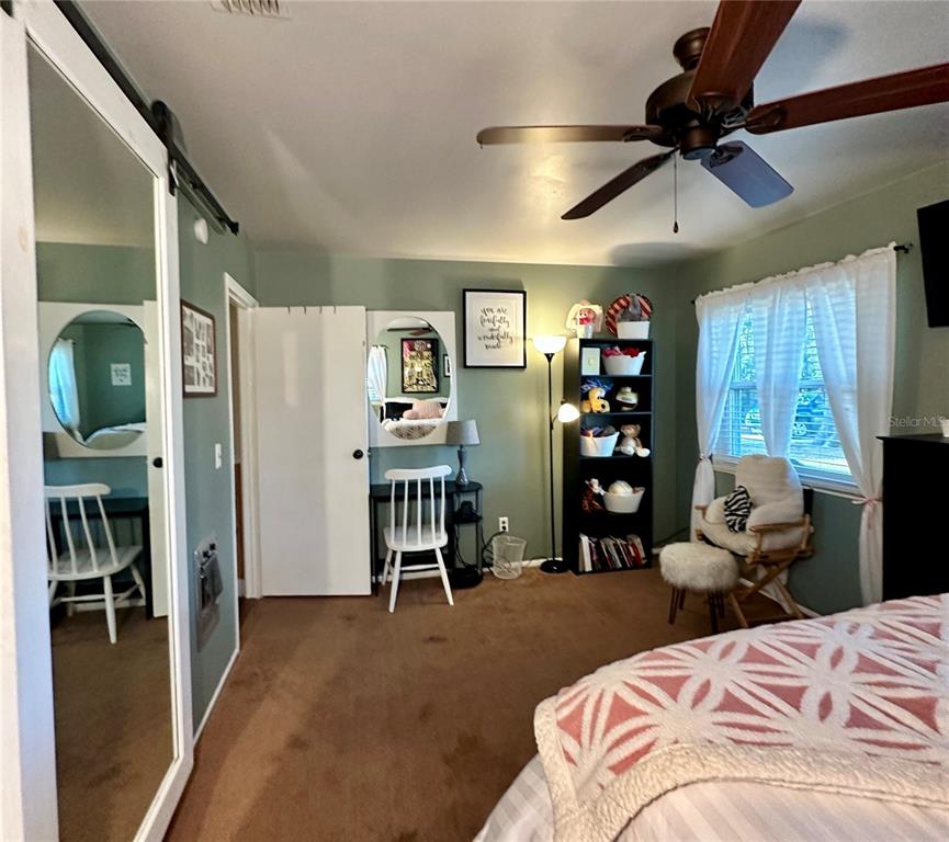 13565 Northeast 38th Avenue Anthony, FL 32617 - Photo 20 of 39 a bedroom with a bed furniture and a window