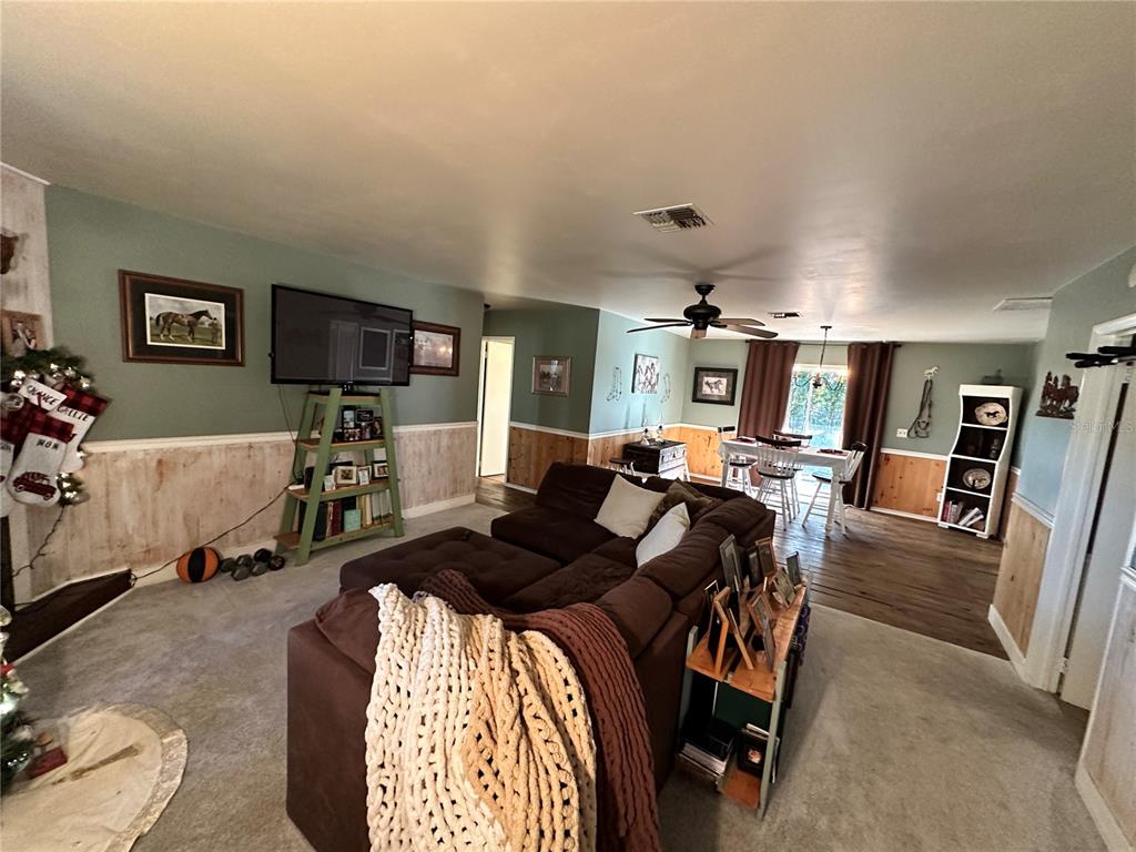 13565 Northeast 38th Avenue Anthony, FL 32617 - Photo 5 of 39 a bedroom with furniture and a flat screen tv