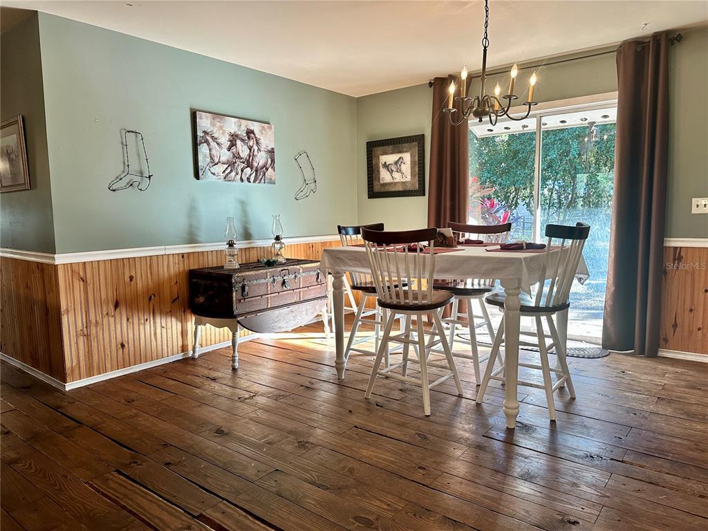 13565 Northeast 38th Avenue Anthony, FL 32617 - Photo 8 of 39 a view of a dining room with furniture window and wooden floor