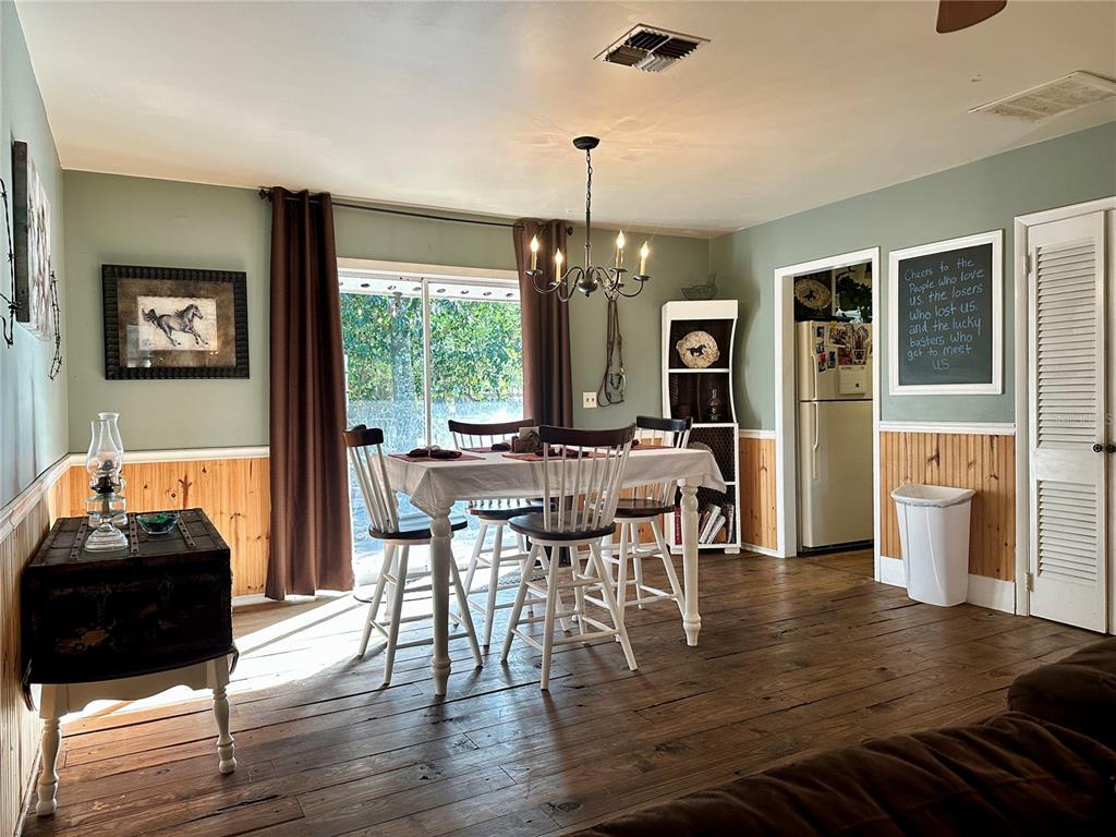13565 Northeast 38th Avenue Anthony, FL 32617 - Photo 9 of 39 a view of a dining room with furniture window and wooden floor