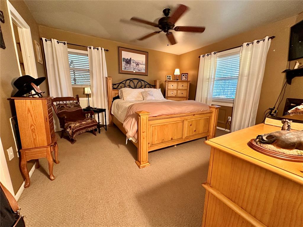 13565 Northeast 38th Avenue Anthony, FL 32617 - Photo 10 of 39 a bedroom with a bed a dresser and a large window