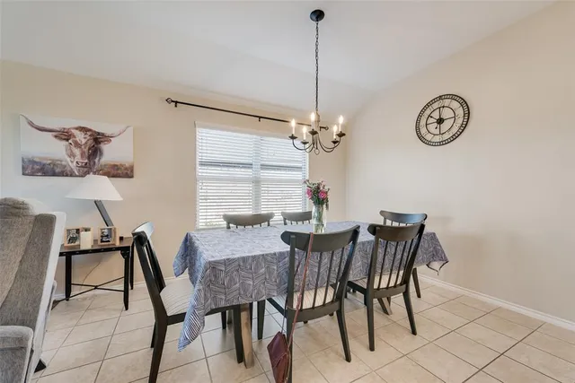 a view of a dining room with furniture and a chandelier