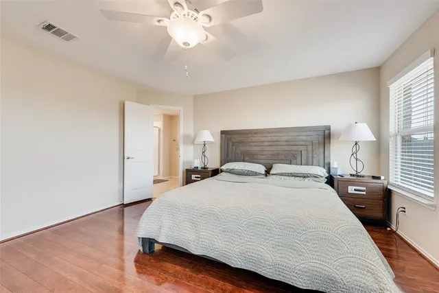 a spacious bedroom with a bed and a chandelier